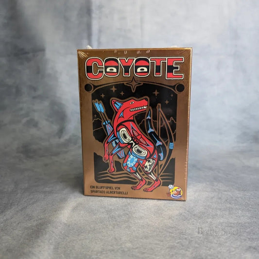 Eine Schachtel des Kartenspiels Coyote von Heidelbär Games mit farbenfrohen stilisierten Coyoten und abstrakten Motiven auf dunklem Hintergrund mit deutschem Text.