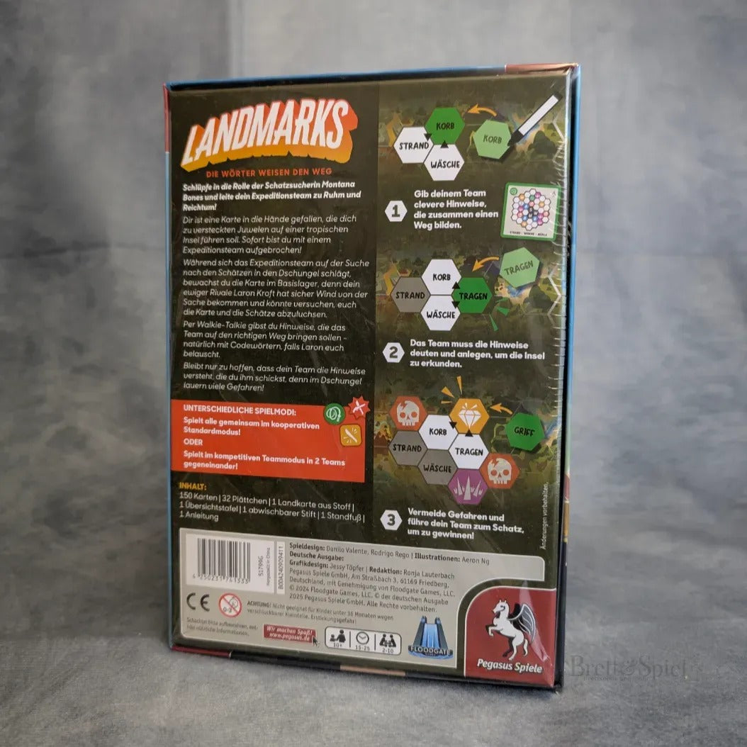 Die Rückseite der Landmarks-Brettspielbox von Pegasus Spiele zeigt Spielanleitungen, Spieler- und Aktionssymbole, farbigen Text und Logos. Erwähnungen der Schatzinsel und eines Expeditionsteams sorgen für Abenteuer. Die Box steht aufrecht auf einem grauen Untergrund.