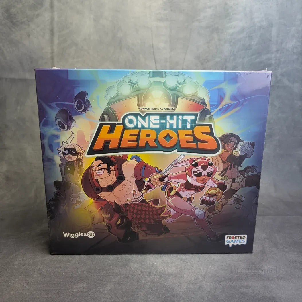 Die One Hit Heroes-Schachtel von Frosted Games zeigt lebendige Cartoon-Helden in Action-Posen mit energiegeladener Beleuchtung, die dieses spannende Boss-Rush-Spiel unterstreichen.