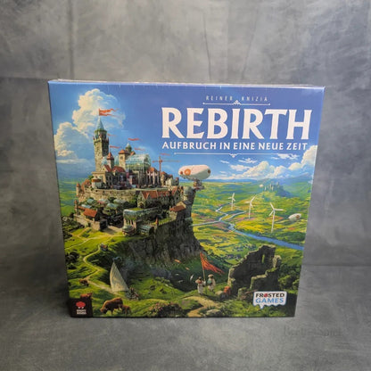 Die Wiedergeburt: Aufbruch in eine neue Zeit Brettspiel von Frosted Games, entworfen von Reiner Knizia, zeigt auf der Schachtel eine Stadt auf einem Hügel mit mittelalterlichen Burgen und Windrädern.