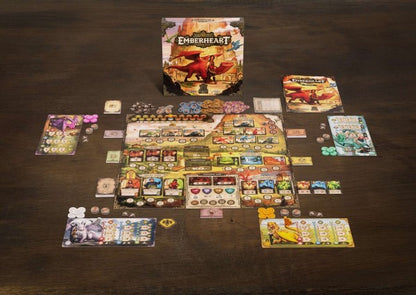 Ein Tabletop-Setup von Glutherz von Mindclash Games - ein lebhaftes Worker-Placement-Spiel mit einem farbenfrohen Spielbrett, Karten, Plättchen, Charaktertafeln und einer Box mit Drachenmotiv - perfekt für Fans von Drachen retten Abenteuern.